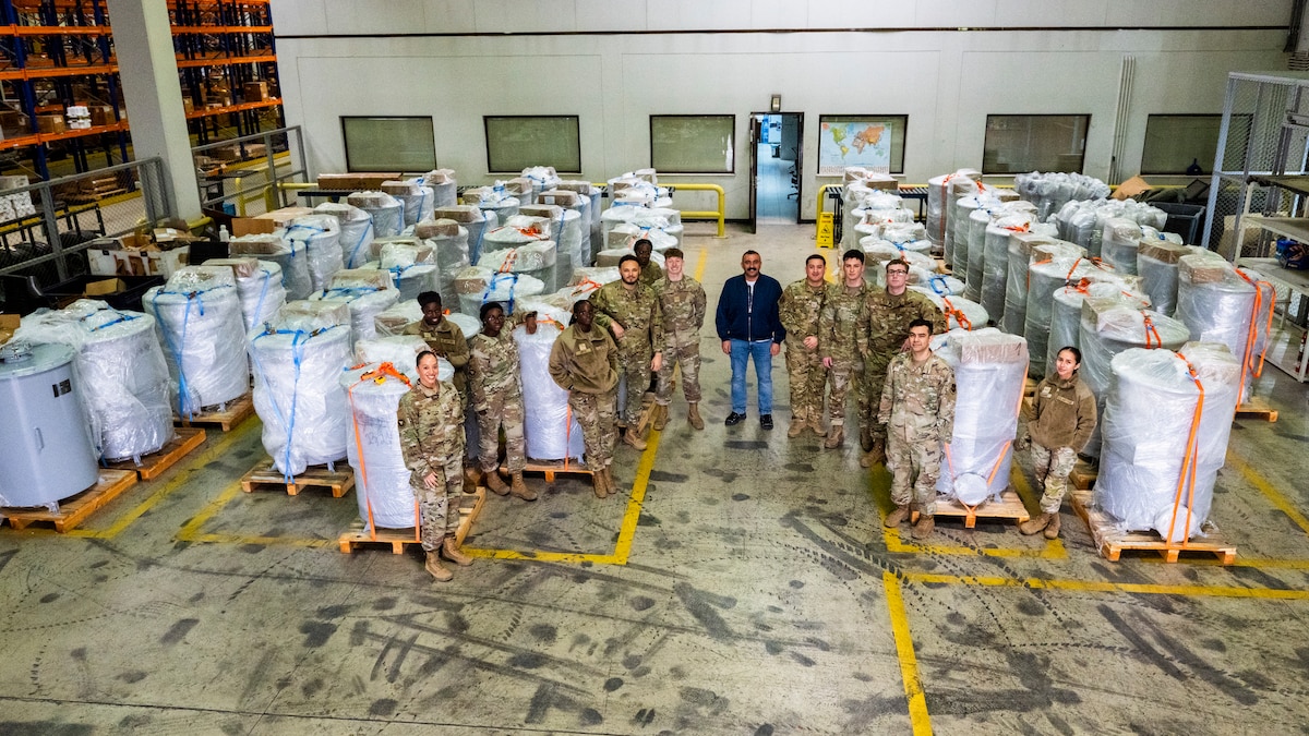 U.S. Airmen and personnel pose for a group photo