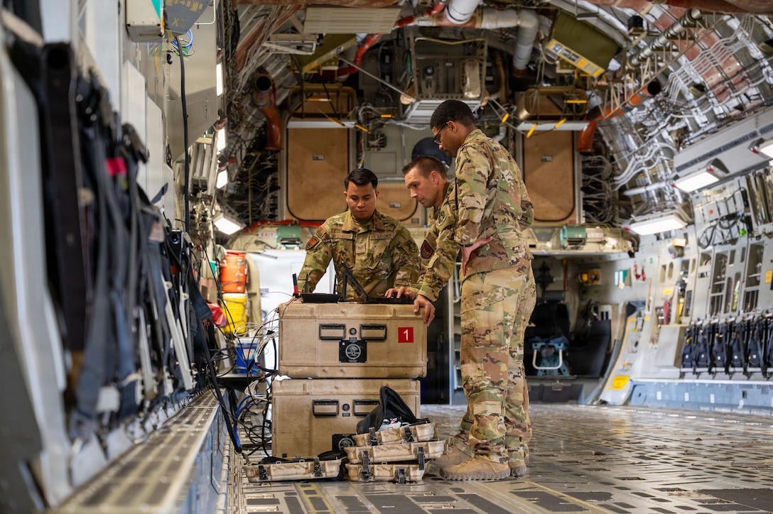 U.S. Air Force Staff Sgt. Edric Hofschneider, Tech. Sgt. Jared Wells, and Tech. Sgt.Johnathan Wright, 379th Expeditionary Communications Squadron Viper Team executive airborne communications technicians, test network access aboard a C-17 Globemaster III aircraft in the U.S. Central Command area of responsibility, Jan. 27, 2026. The Viper Team conducts tail tests aboard newly arrived aircraft to ensure the aircraft are cleared to support senior leader transport missions that require in-flight network connectivity. (U.S. Air Force photo by Tech. Sgt. Kristen Pittman)