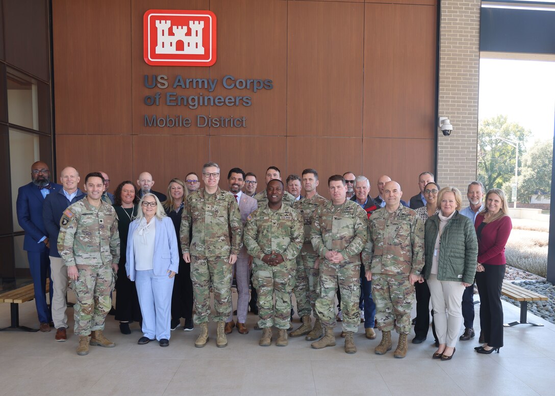 Leadership in front of a building.