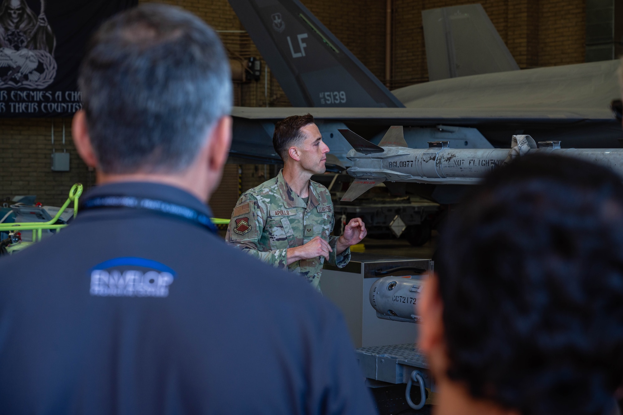 Members of the Department of War Maintenance Symposium, watch U.S. Air Force Senior Airman Kyle Apollo , 56th Component Maintenance Squadron load crew member, load ammunitions on a U.S. Air Force F-35A Lightning II, Jan. 20, 2026, at Luke Air Force Base, Arizona.