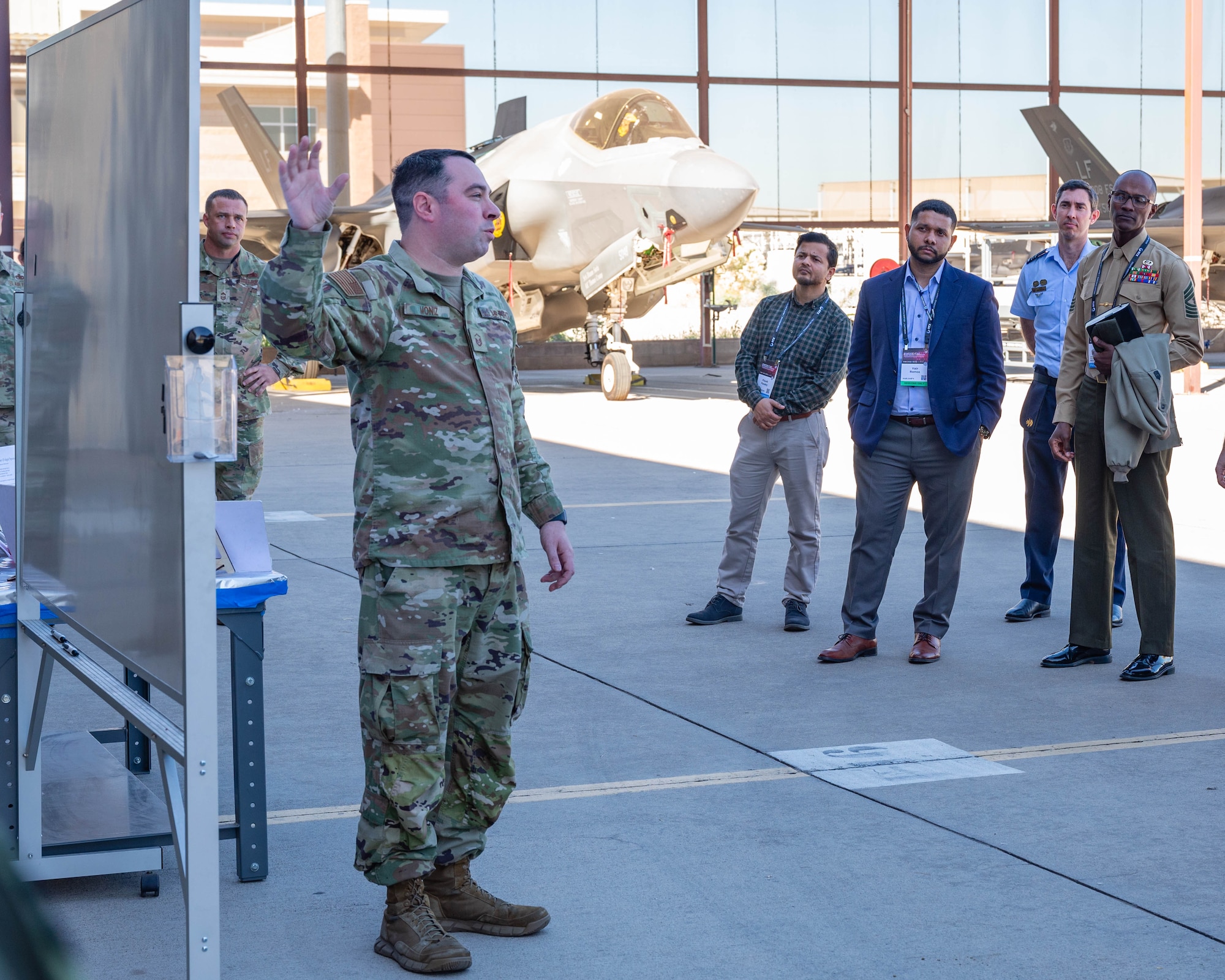 Members of the Department of War Maintenance Symposium, listen to U.S. Air Force Master Sgt. Jacob Moniz, 56th Equipment Maintenance Squadron production superintendent, talk about the operations of the F-35A Lightning II, Jan. 20, 2026, at Luke Air Force Base, Arizona.