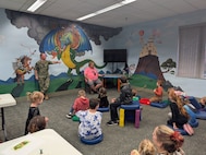Chief Warrant Officer 3 Adam Schumacher (left), the Nuclear Weapons Security Officer, and Jeff Chafin (right), a technical writer, answer questions from K-12 students about science, technology, engineering and mathematics (STEM)-related careers at the Camden County Public Library in Kingsland, Ga., on Jan. 21, 2026. SWFLANT hosts a Storybook STEM series throughout the year, offering K-12 students a unique opportunity to learn basic engineering principles from children’s books and support their understanding on how these lessons apply to real-world Navy science and technology. (U.S. Navy photo provided)