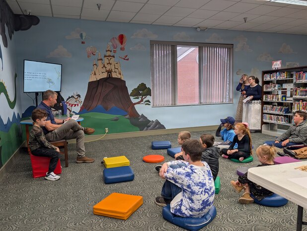 Rob Birke, a supervisory security specialist at Strategic Weapons Facility, Atlantic (SWFLANT), reads “The Tale of Peter Rabbit,” to students at the Camden County Public Library in Kingsland, Ga., on Jan. 21, 2026. The reading was part of SWFLANT’s Storybook STEM series, which offers K-12 students a unique opportunity to learn basic engineering principles from children’s books and understand how they apply to real-world Navy science and technology. (U.S. Navy photo provided)