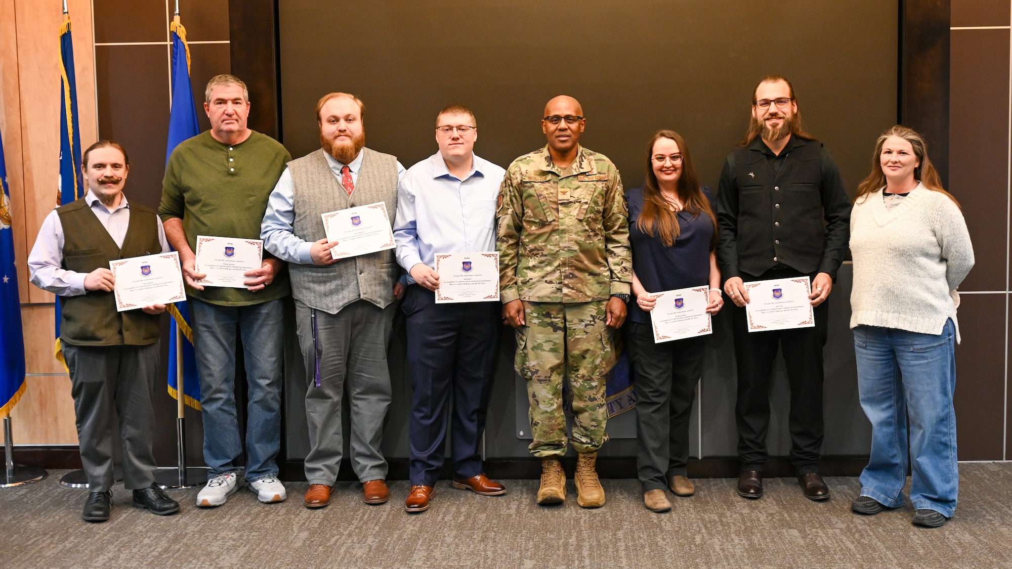 Men pose with certificate