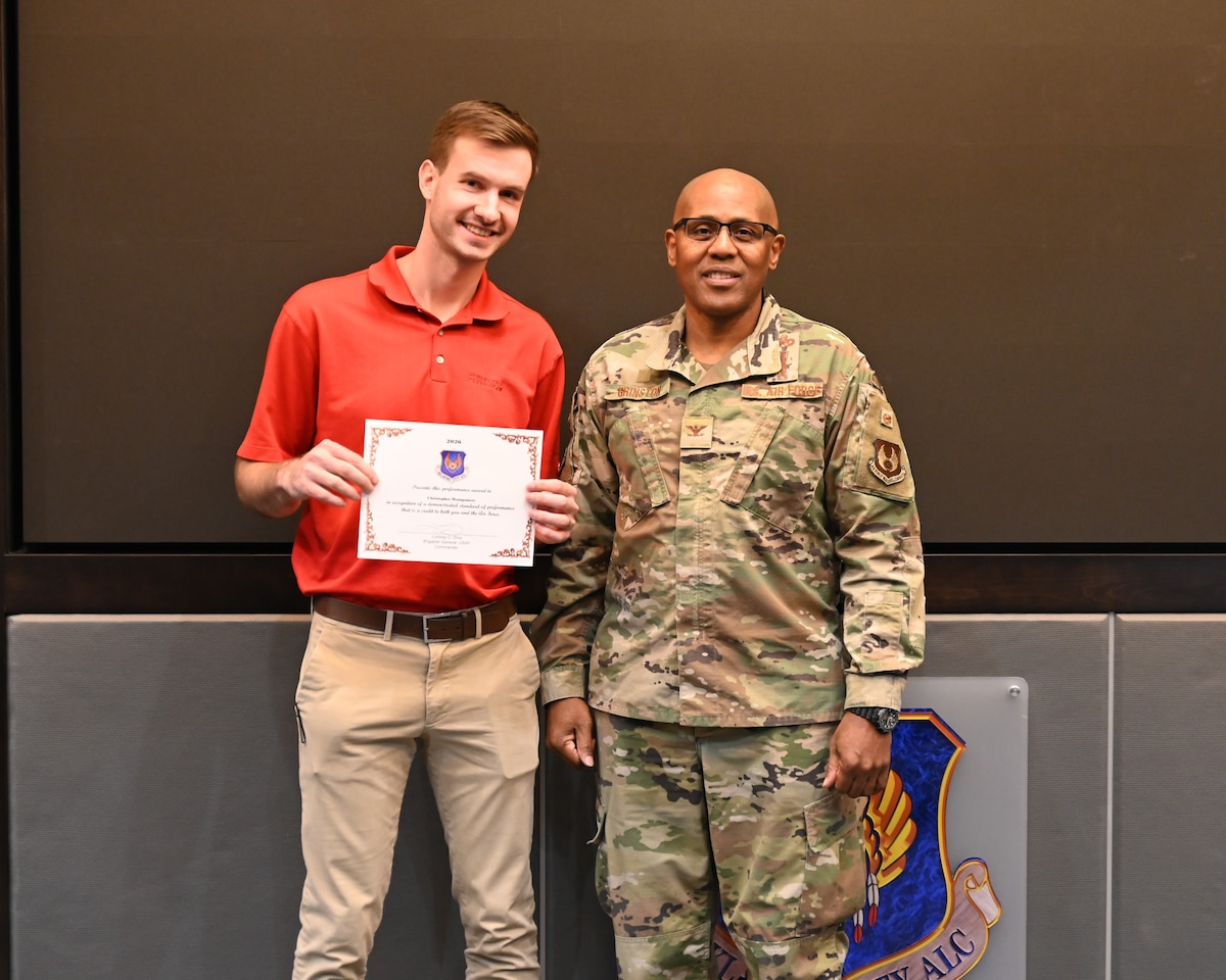 Men posing with certificate