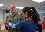 Lt. Alex Pantages, assigned to Naval Medical Center Portsmouth (NMCP), demonstrates the proper application of a tourniquet to students from local schools during a Stop The Bleed event at the Chesapeake Career Center, Jan. 23, 2025.