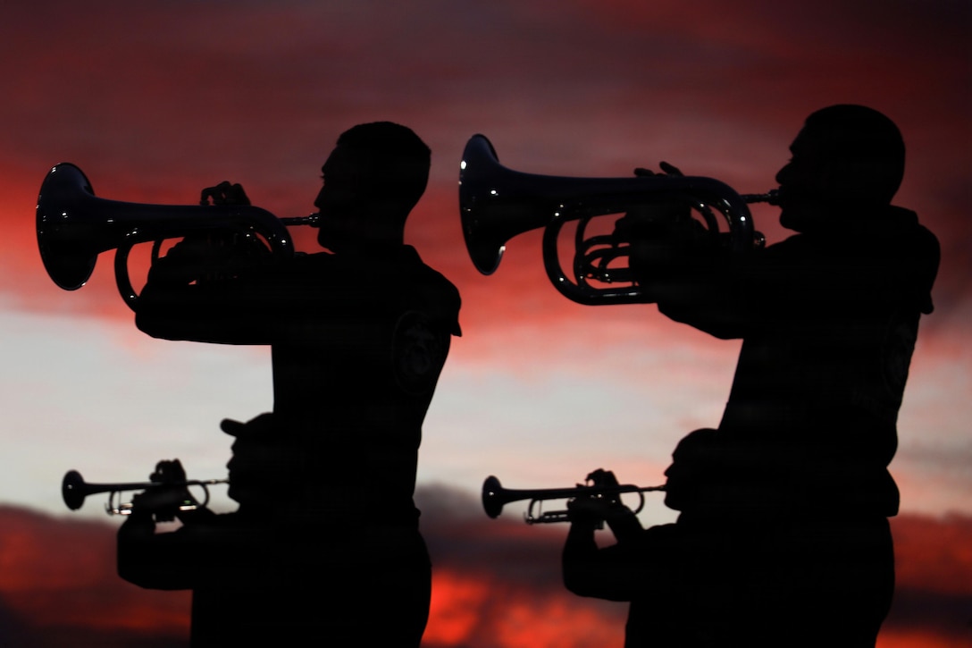 Four silhouettes of people playing brass musical instruments under a red and white sky.