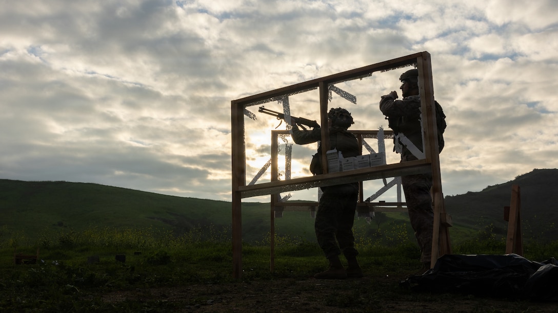 U.S. Marine Corps Capt. Mason Wallace, right, the officer in charge of Combat Skills Training School with 1st Marine Logistics Group, supervises a Marine during a counter-small unmanned aerial systems shotgun range at Marine Corps Base Camp Pendleton, California.