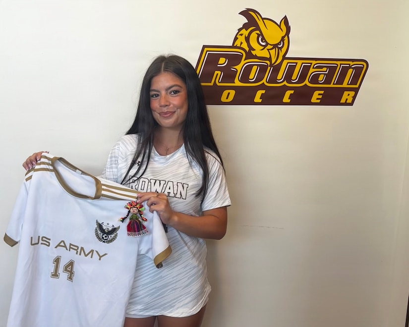 U.S. Army 1st Lt. Daniela McCurdy, a human resources officer with the 56th Stryker Brigade Combat Team, 28th Infantry Division, Pennsylvania National Guard, poses for a photo in her Rowan uniform with her jersey from her time playing soccer with Area Support Group - Kuwait during a media day event in Glassboro, New Jersey, Aug. 27, 2025. (Courtesy Photo)