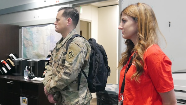 Seattle District employee Tessa Rough stans alongside Seattle District Deputy Commander Major O'Donnell in Joint Base Lewis-McChord Emergency Operations Center.