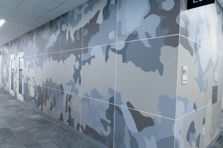 A grey wall with grey carpet.