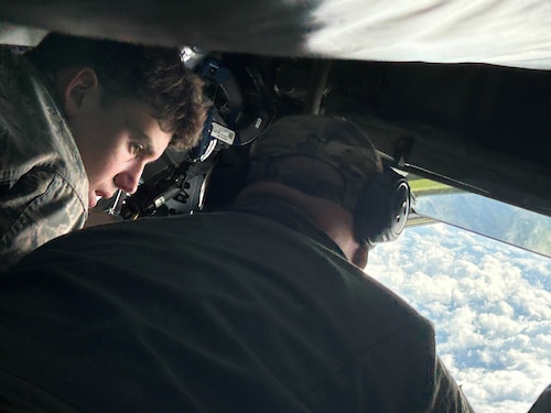 A civil air patrol cadet watches as a plane is refueled