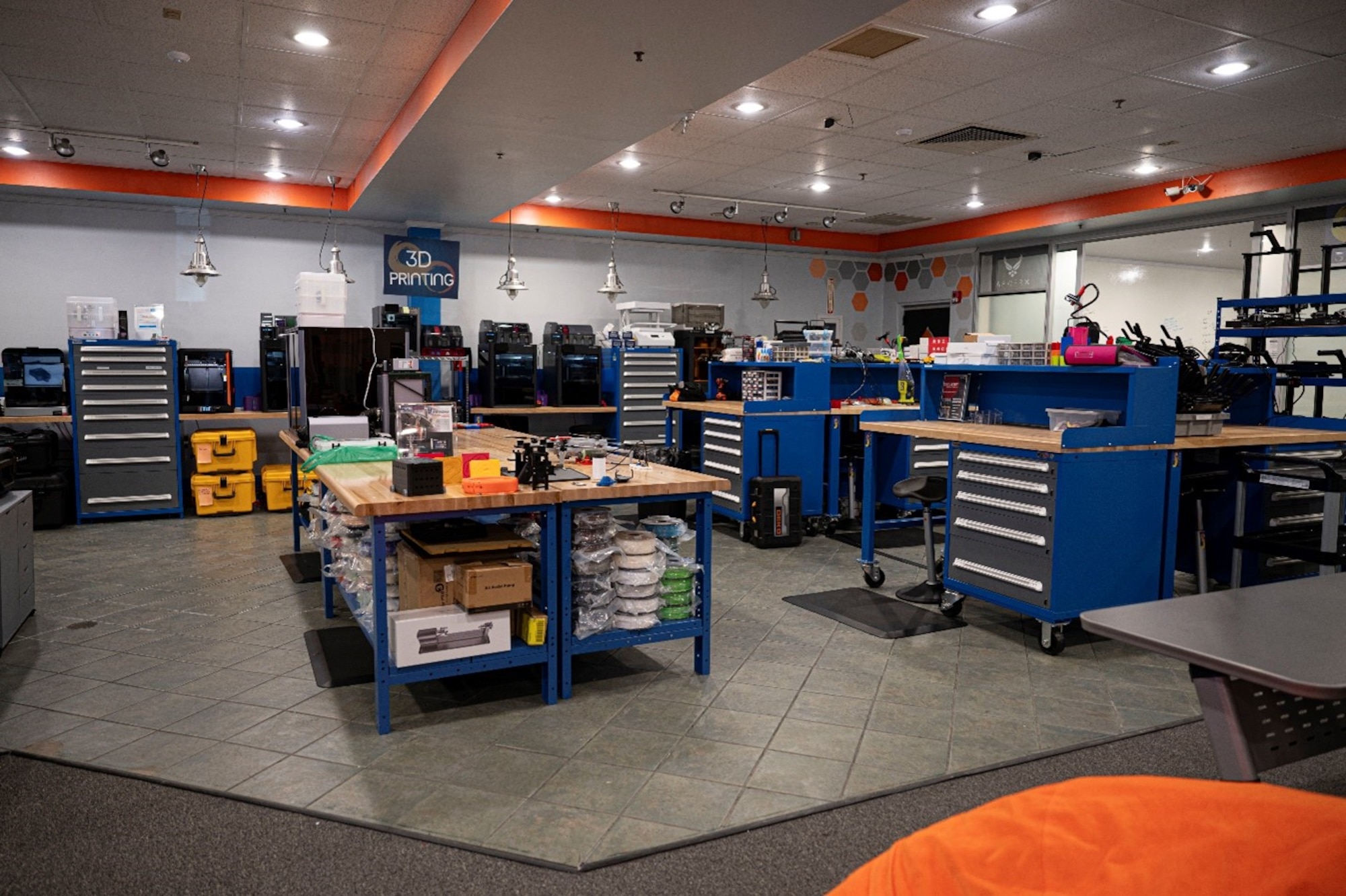 U.S. Air Force Mission Enhancement Cell 3D printers and workstations are setup at Joint Base McGuire-Dix-Lakehurst, N.J., Nov. 5, 2025. By utilizing advanced additive manufacturing, the MEC develops and produces tools that enhance operational capabilities and efficiency. (U.S. Air Force photo by Airman 1st Class Luisa E. Dugan)