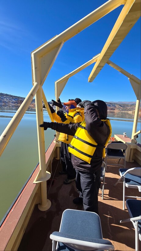 Volunteers look for eagles from a patrol boat on Abiquiu Lake during the midwinter eagle survey, Jan. 10, 2026. 12 eagles were spotted by volunteers during the event.