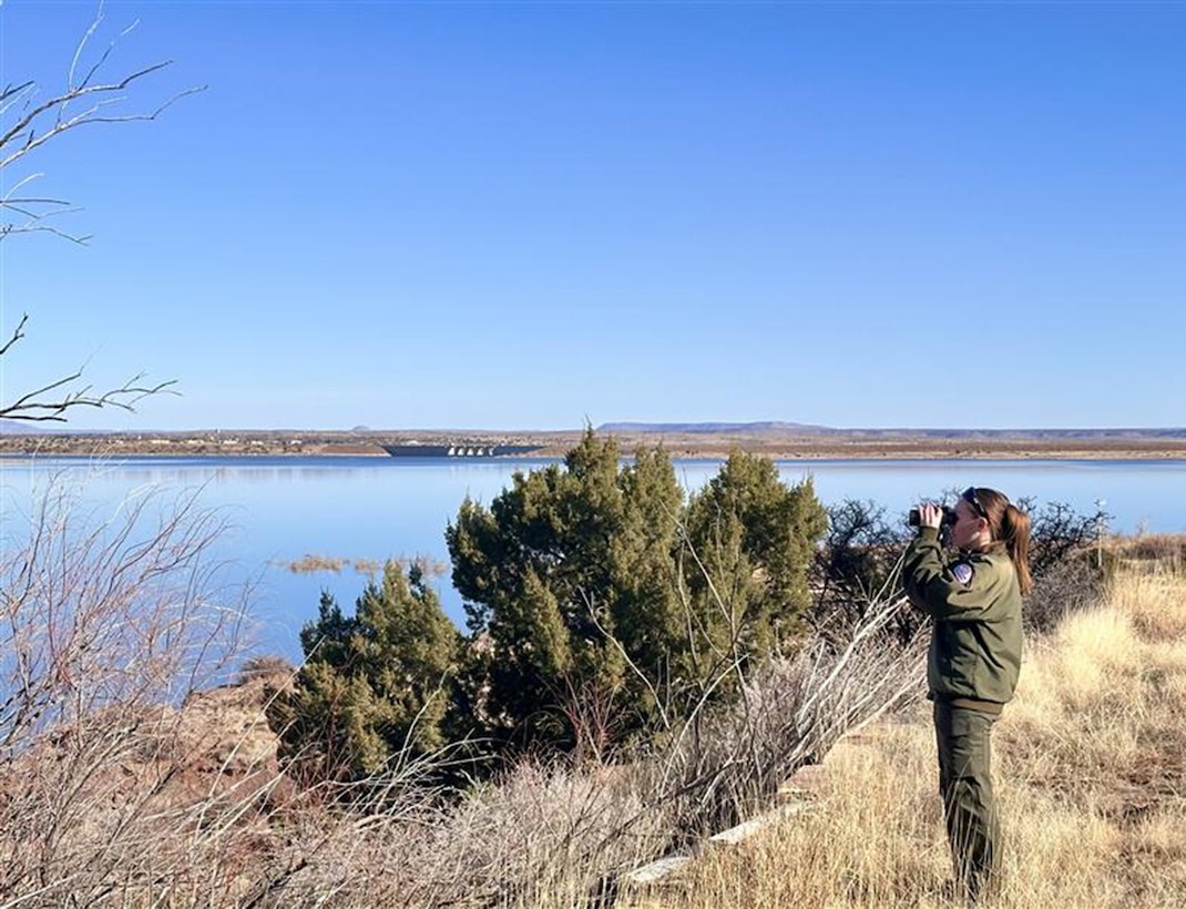 Park Ranger Rachel Snedden looks for eagles from her position near the Southside Lodge at Conchas Lake, N.M., during the midwinter eagle survey, Jan. 16, 2026. “Ranger Snedden was eager to get involved and experience firsthand the importance of monitoring these incredible birds,” said Lead Conchas Park Ranger Justin Gibson.
