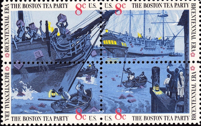 A postage stamp with people on a sailing vessel throwing boxes overboard as others in row boats holding lanterns row at night. Another ship is in the distance, and people are standing on a pier watching the activities.