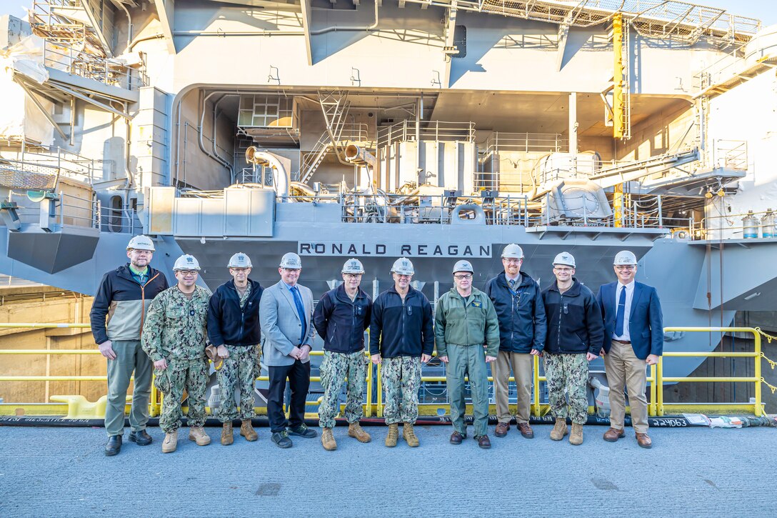 Adm. John Kilby, vice chief of naval operations, poses for a group photo with senior leaders and members of the official party, Jan. 23, 2026, at Puget Sound Naval Shipyard & Intermediate Maintenance Facility in Bremerton, Washington. (U.S. Navy photo by Jeb Fach)