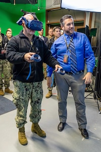 Adm. John Kilby, vice chief of naval operations, tests a virtual reality simulator with the help of Jason Fraser, deputy engineering & planning, Code 201, Engineering & Planning, Jan. 23, 2026, at Puget Sound Naval Shipyard & Intermediate Maintenance Facility in Bremerton, Washington. (U.S. Navy photo by Jeb Fach)
