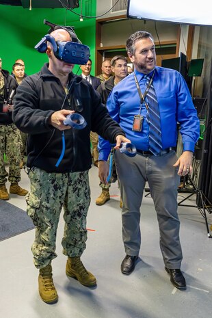 Adm. John Kilby, vice chief of naval operations, tests a virtual reality simulator with the help of Jason Fraser, deputy engineering & planning, Code 201, Engineering & Planning, Jan. 23, 2026, at Puget Sound Naval Shipyard & Intermediate Maintenance Facility in Bremerton, Washington. (U.S. Navy photo by Jeb Fach)