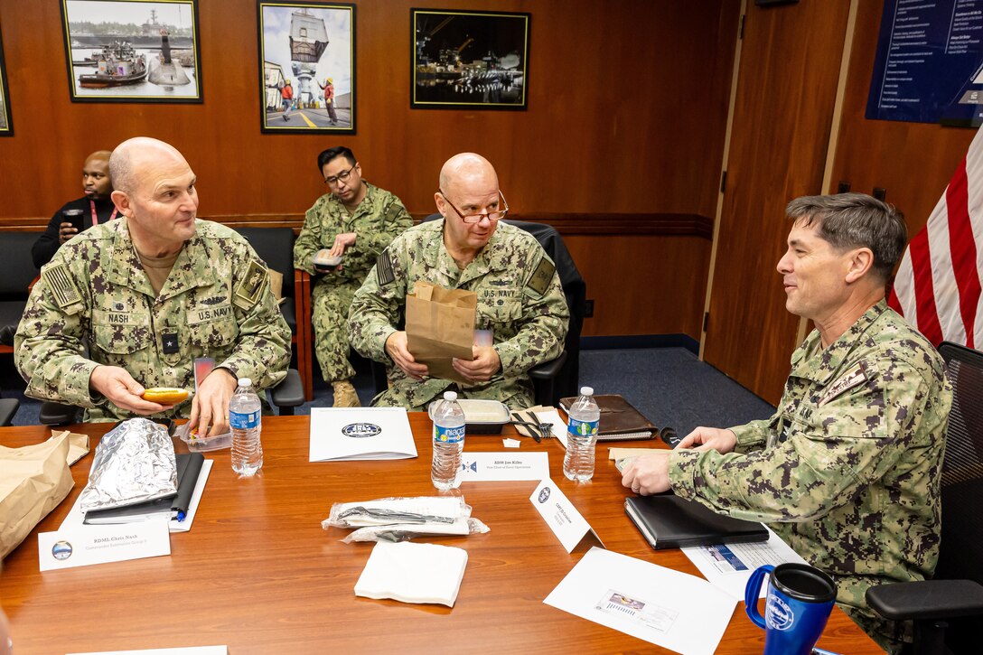 Adm. John Kilby, vice chief of naval operations (middle), and Rear Adm. Christopher Nash, commander, Submarine Group Nine, meet with Capt. JD Crinklaw, commander, Puget Sound Naval Shipyard & Intermediate Maintenance Facility, Jan. 23, 2026, in Bremerton, Washington. (U.S. Navy photo by Jeb Fach)