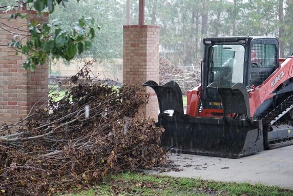 Ten Airmen from the 165th Civil Engineering Squadron, 165th Airlift Wing, clear trees and other debris from a school September 4, 2021 in Parish of Saint Tammany, Louisiana, which is located north of New Orleans. These Airmen are working as quickly and safely as possible to clear the school property and roads around it so that children in the neighborhood can return to school as soon as possible.