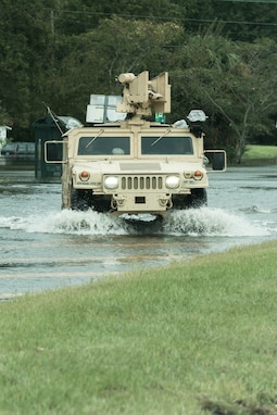 SAVANNAH, Ga., October 8, 2016 - Soldiers with the 178th Military Police Company based in Monroe, ford through standing water at an intersection in West Chatham County while helping Savannah Chatham Metropolitan Police with patrolling duties. Georgia National Guard photo by Staff Sgt. Mike Perry/released