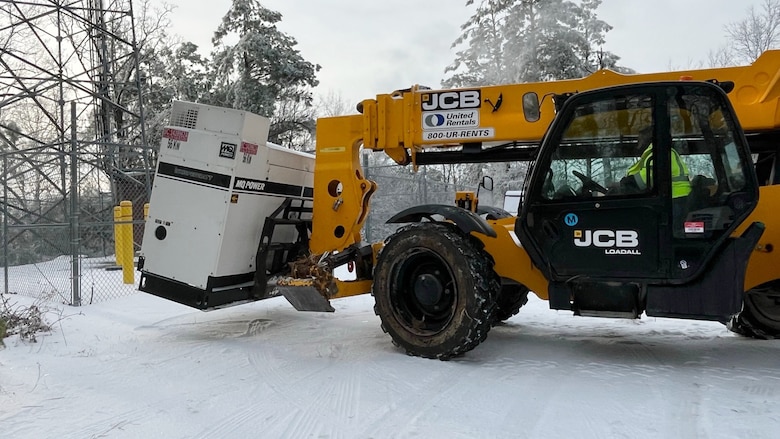 A power team from the U.S. Army Corps of Engineers Tulsa District moves a power generator into position at a communications tower in Bethel Springs, Tennessee, Jan. 29, 2026, to ensure first responders can communicate and coordinate recovery efforts. The USACE Nashville District’s emergency managers are supporting this effort as part of a FEMA mission assignment with Task Force Temporary Emergency Power. (USACE Photo by Matt Phelan)