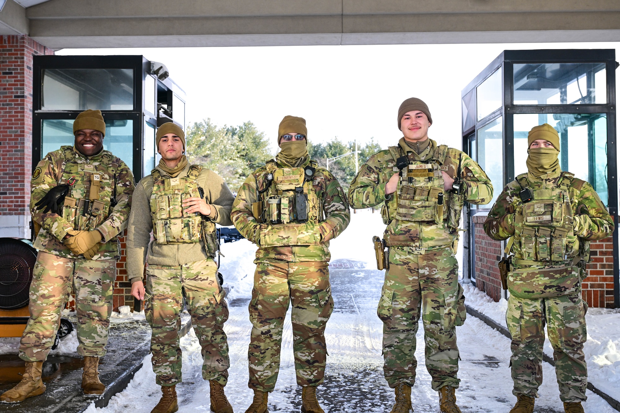 A group of 5 individuals wearing military uniforms, standing at the Scott Air Force Base Shiloh Gate.