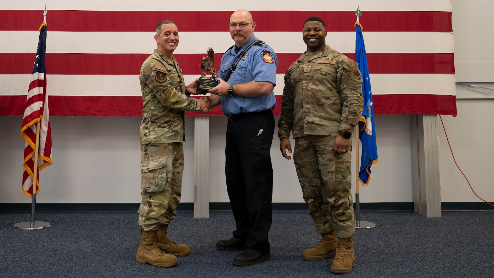 Airmen pose for a group photo with award