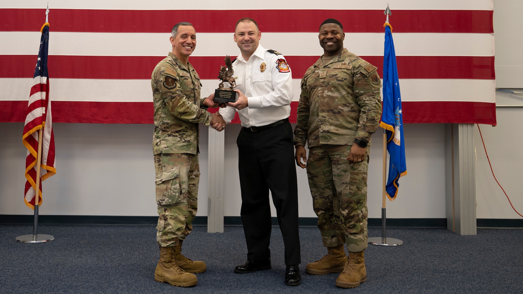 Airmen pose for a group photo with award