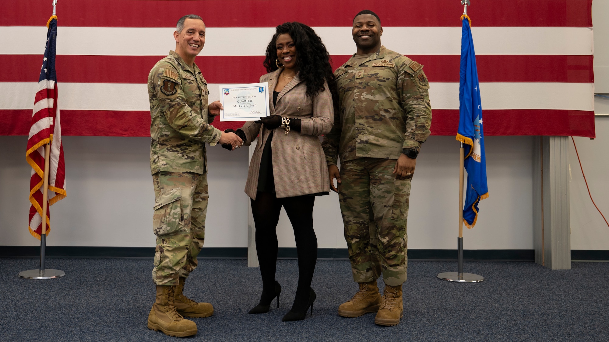 Airmen pose for a group photo with award
