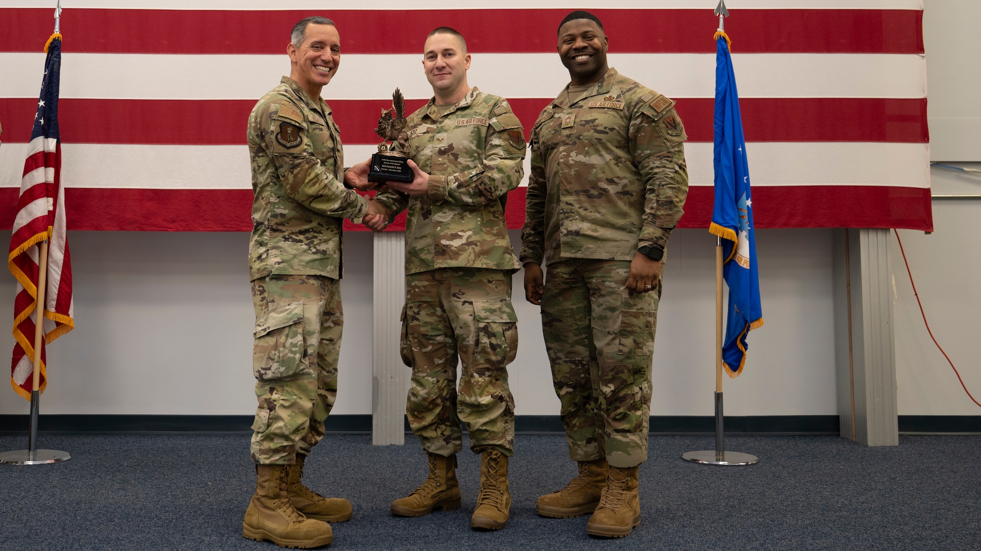 Airmen pose for a group photo with award