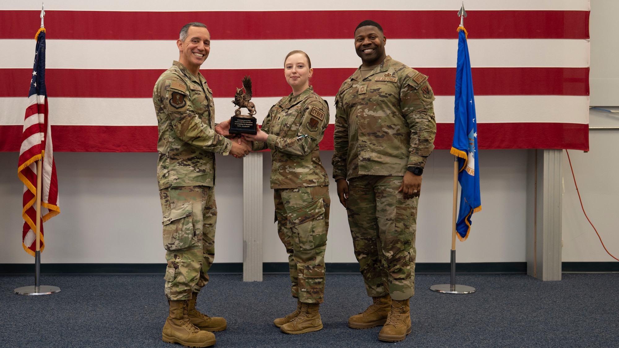 Airmen pose for a group photo with award