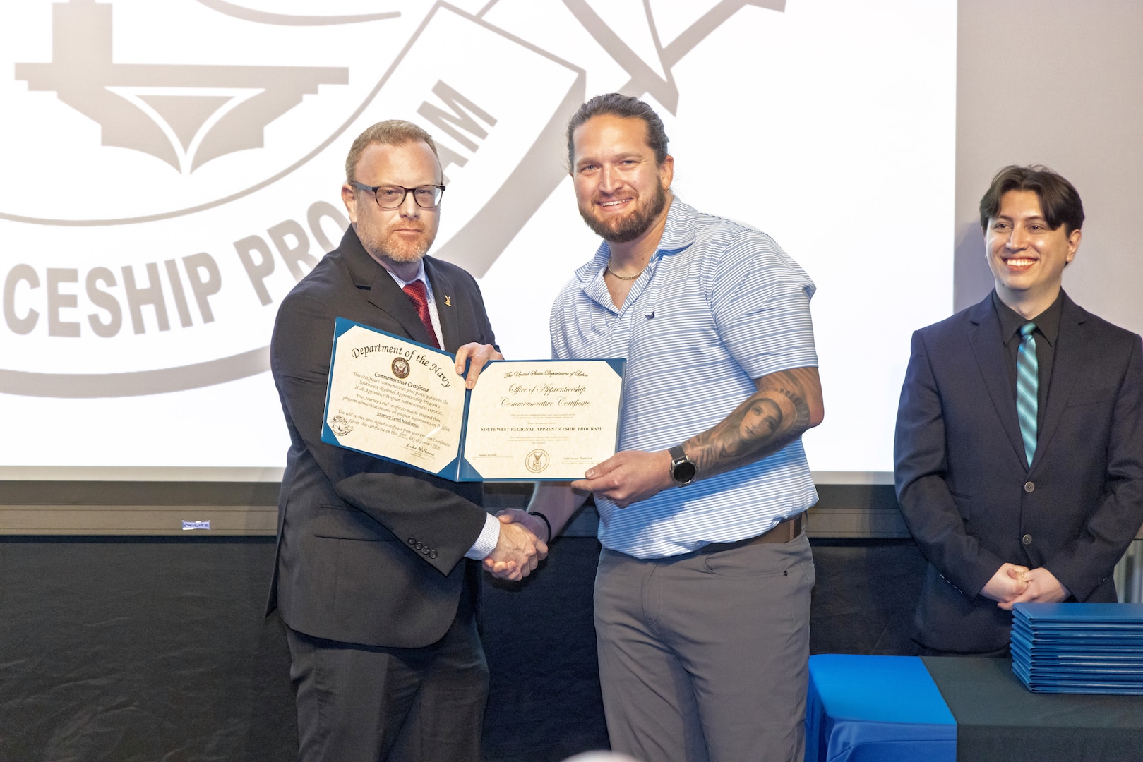 Mitchell Lamb, right, marine electrician, PSNS & IMF San Diego Detachment, receives his certificate, Jan. 22, 2026, during the 2026 Southwest Regional Apprentice Program graduation ceremony at Southwestern College, Chula Vista, California. (U.S. Navy photo by Wendy Hallmark)