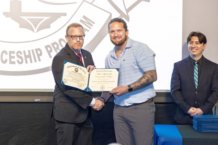 Mitchell Lamb, right, marine electrician, PSNS & IMF San Diego Detachment, receives his certificate, Jan. 22, 2026, during the 2026 Southwest Regional Apprentice Program graduation ceremony at Southwestern College, Chula Vista, California. (U.S. Navy photo by Wendy Hallmark)