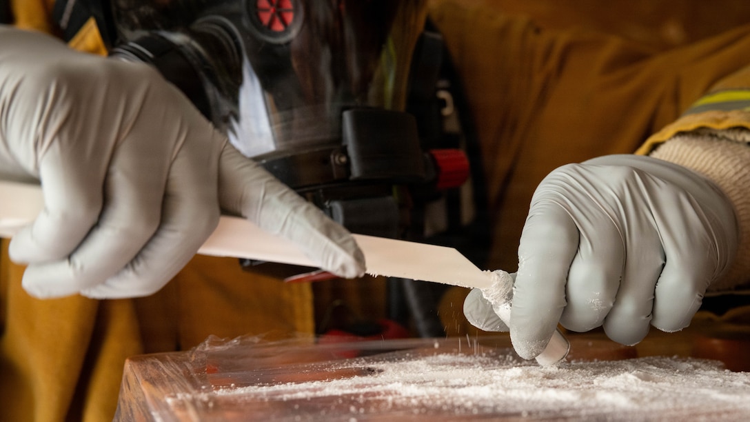 A member of the Camp Pendleton Fire Department collects a sample during a hazmat training exercise during Command Post Exercise II at Marine Corps Base Camp Pendleton, California, Jan. 28, 2026. CPX II combined the efforts of various agencies across MCIWEST to exercise staff actions in response to a simulated food supply contamination, including verifying the safety and security of food sources, assessing the impact of food delivery interruptions, identifying response actions to restore safe food deliveries, and exercising the Camp Pendleton Fire Department’s procedures for hazardous materials incidents. (U.S. Marine Corps photo by Cpl. Jacqueline Akamelu)