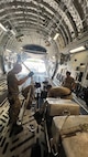 Airmen from the 48th Aerial Port Squadron and the 735th Air Mobility Squadron reposition cargo inside an aircraft at Joint Base Pearl Harbor-Hickam, Hawaii, Nov. 13, 2025.