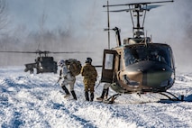 U.S. Army Soldiers assigned to the 3rd Battalion, 509th Infantry Regiment, 2nd Infantry Brigade Combat Team, 11th Airborne Division, dismount a Sikorsky UH-60 Blackhawk helicopter as part of an aerial insertion training exercise during North Wind 26 on Hokudai-en, in Hakkaido, Japan, Jan. 28, 2026.