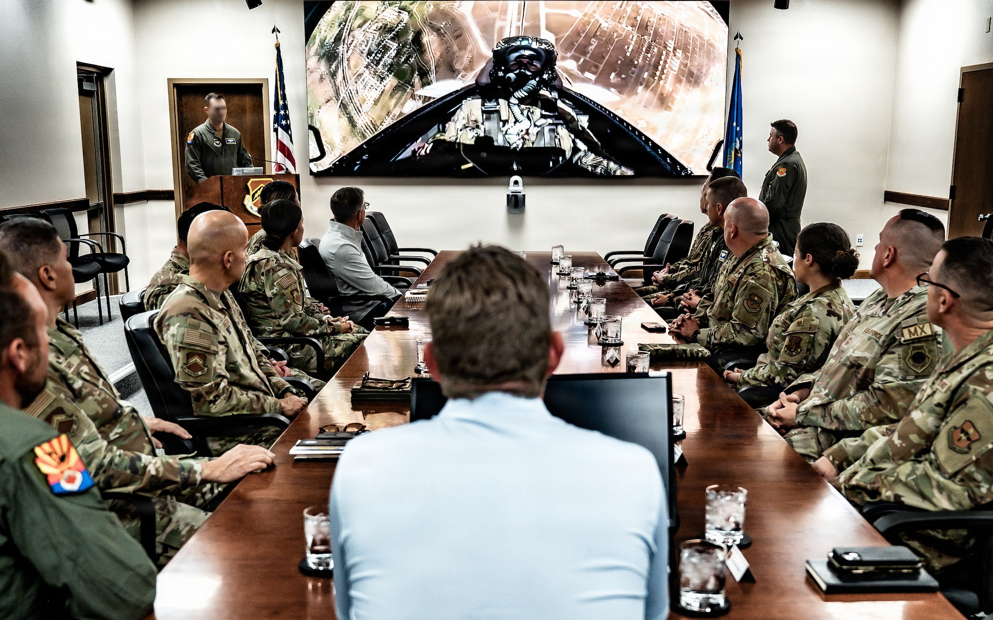 U.S. Air Force Col. John Ryan, 56th Fighter Wing deputy commander, and base leadership give a command mission brief to Mr. Eric Trump during his visit to the installation, Jan. 28, 2026, Luke Air Force Base, Arizona. The briefing highlighted Luke AFB’s mission, capabilities and role in training the world’s greatest fighter pilots and combat ready Airmen. (U.S. Air Force photo by Airman 1st Class Belinda Guachun-Chichay)