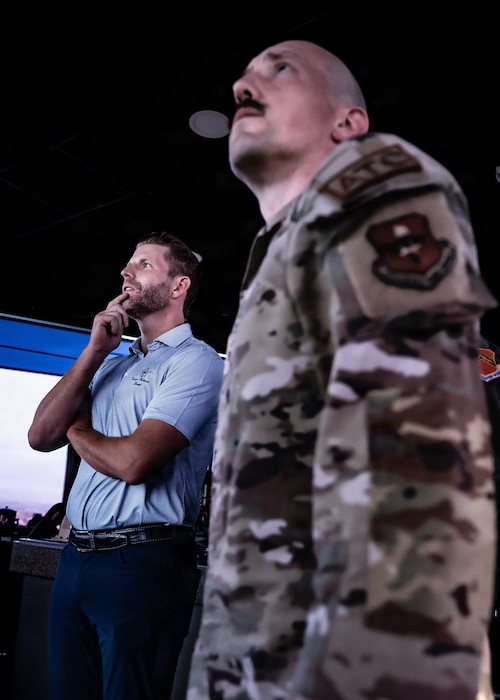 U.S. Air Force Senior Master Sgt. Christopher Farwick, 56th Operations Support Squadron tower chief controller, briefs Mr. Eric Trump on the 56th Fighter Wing’s airfield operations highlighting the scale complexity and global training mission of the world’s largest fighter base, Jan. 28, 2026, at Luke Air Force Base, Arizona. (U.S. Air Force photo by Airman 1st Class Belinda Guachun-Chichay)