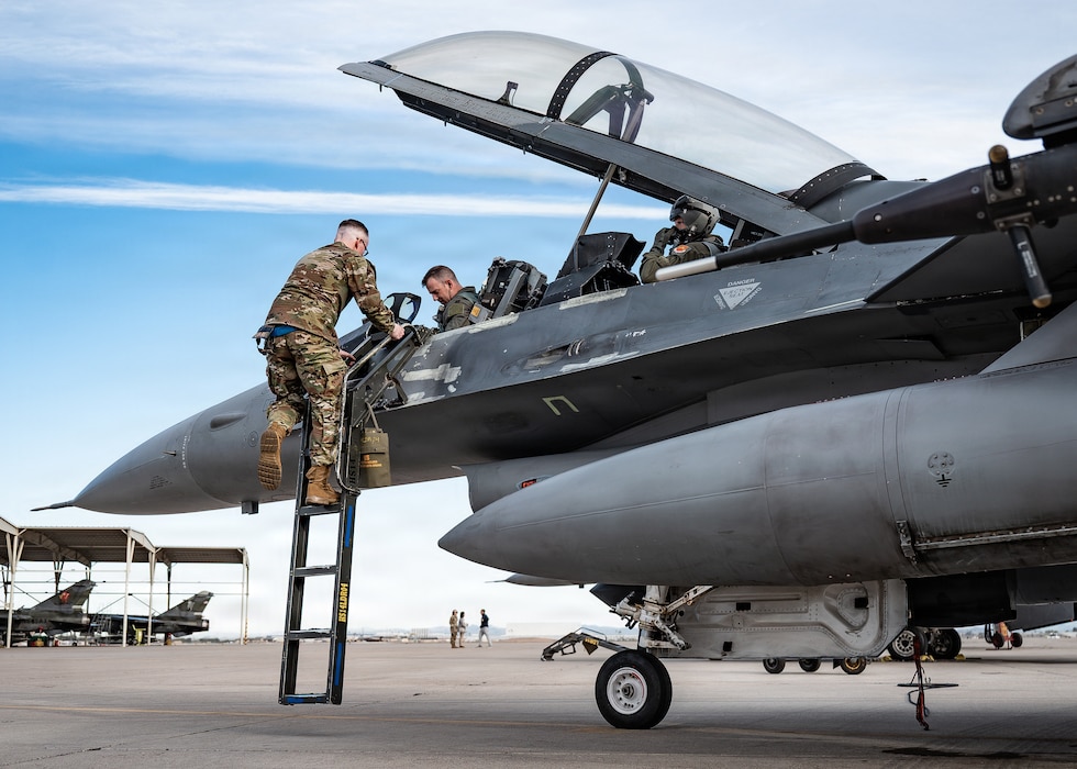 U.S. Air Force Airmen from the 49th Fighter Wing, conduct pre-flight operations, with Mr. Eric Trump, on an F-16 Fighting Falcon during a training event, Jan. 29, 2026, at Luke Air Force Base, Arizona. The hands-on engagement provided an up-close view of fourth- and fifth generation fighter integration, reinforcing the importance of training, readiness, and interoperability in maintaining dominance and superiority in the air. (U.S. Air Force photo by Airman 1st Class Belinda Guachun-Chichay)