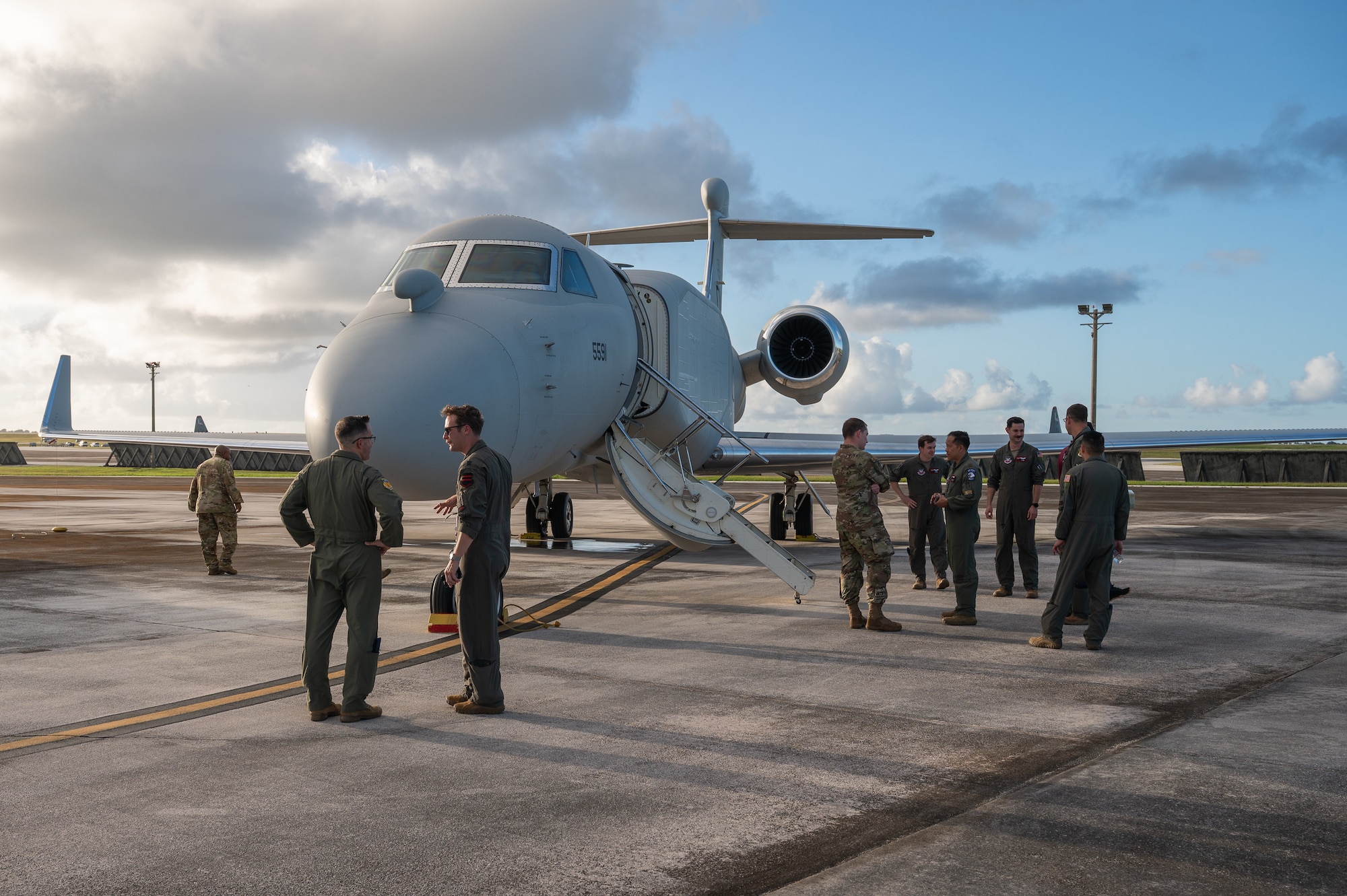 The flight crew of an EA-37B Compass Call aircraft assigned to Davis-Monthan Air Force Base, Arizona, speak with 36th Operations Group leadership at Andersen AFB, Guam, Dec. 12, 2025. The EA-37B sustains joint force military advantage in the electromagnetic battlespace and builds a more lethal force by modernizing electromagnetic attack capabilities to deny peer competitors' tactical networks and information ecosystems.