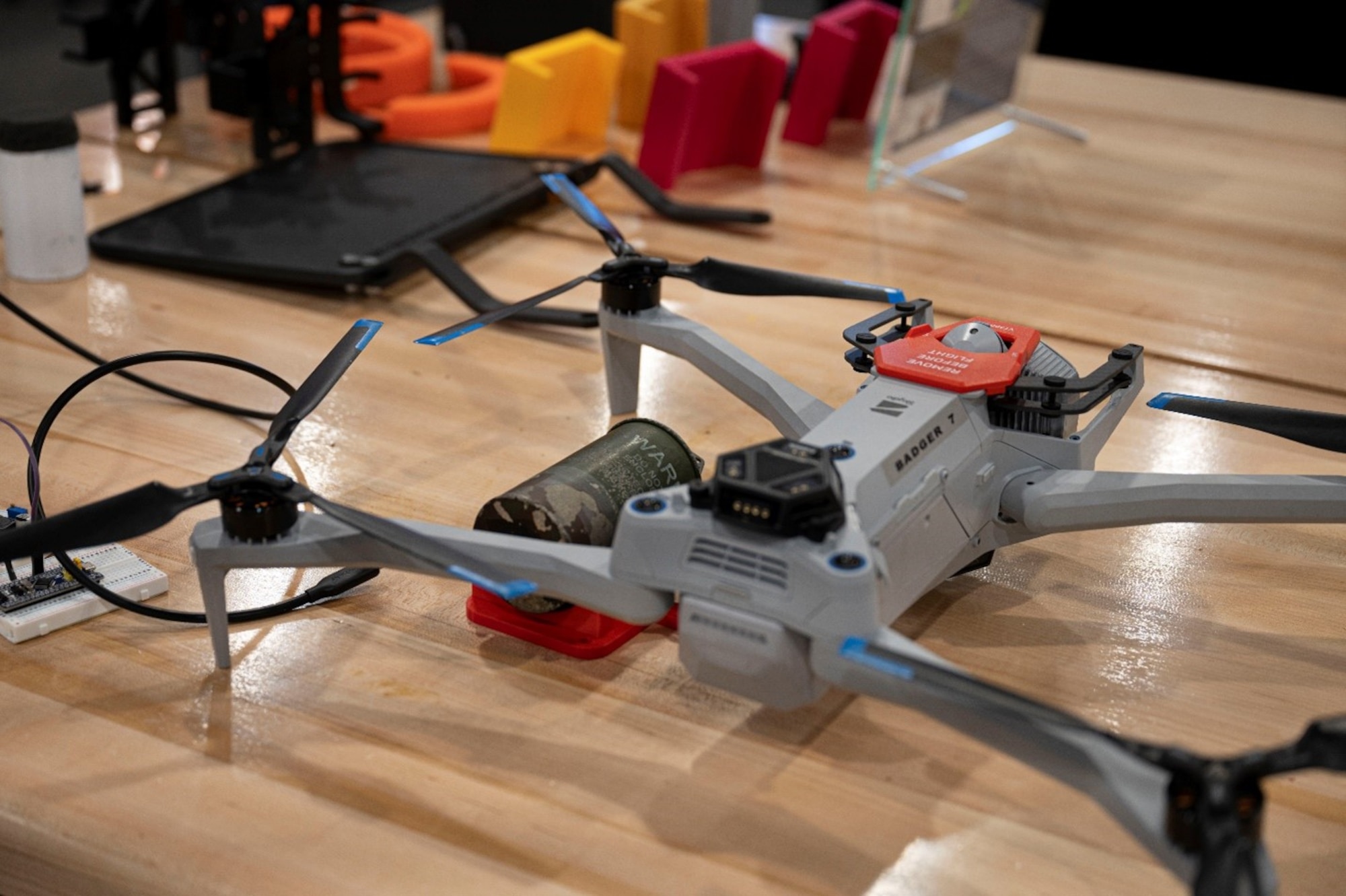 A 3D printed drone attachment prototype for the Badger 7 drone is on display in the Mission Enhancement Cell at Joint Base McGuire-Dix-Lakehurst, N.J., Nov. 5, 2025. As a hub for continuous improvement, the MEC pioneers and implements innovative solutions for the entire joint base. (U.S. Air Force photo by Airman 1st Class Luisa E. Dugan)