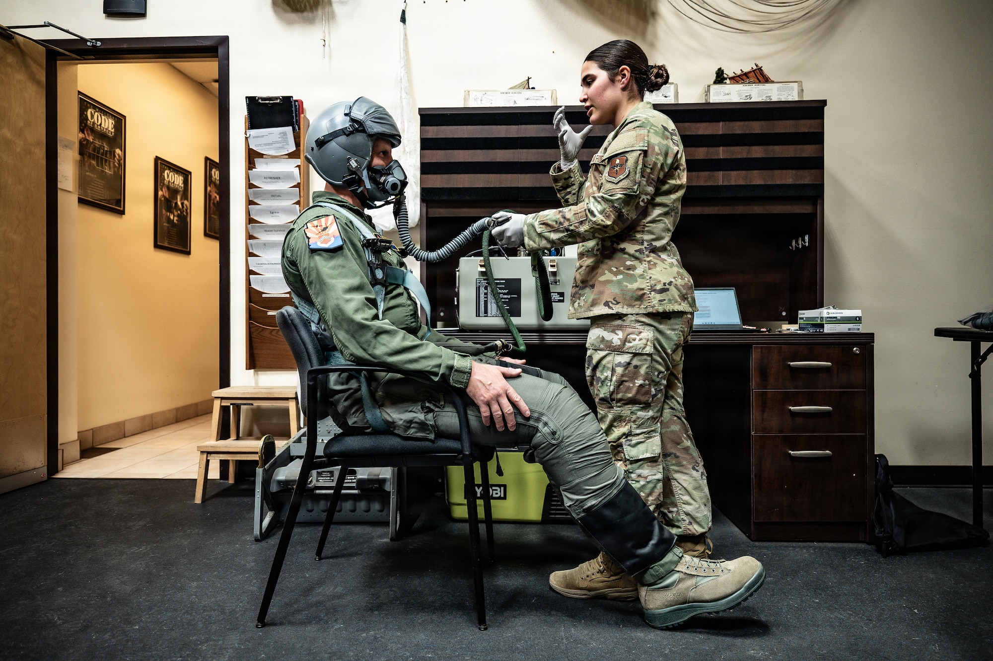 U.S. Air Force Senior Airman Mia Thomas (right), 54th Operations Support Squadron aircrew flight equipment technician, integrates Luke and Holloman’s mission to relentlessly master fundamental warfighting skills by highlighting how they maintain pilot survival and flight equipmen, Jan. 28, 2026, at Luke Air Force Base, Arizona. (U.S. Air Force photo by Airman 1st Class Belinda Guachun-Chichay)