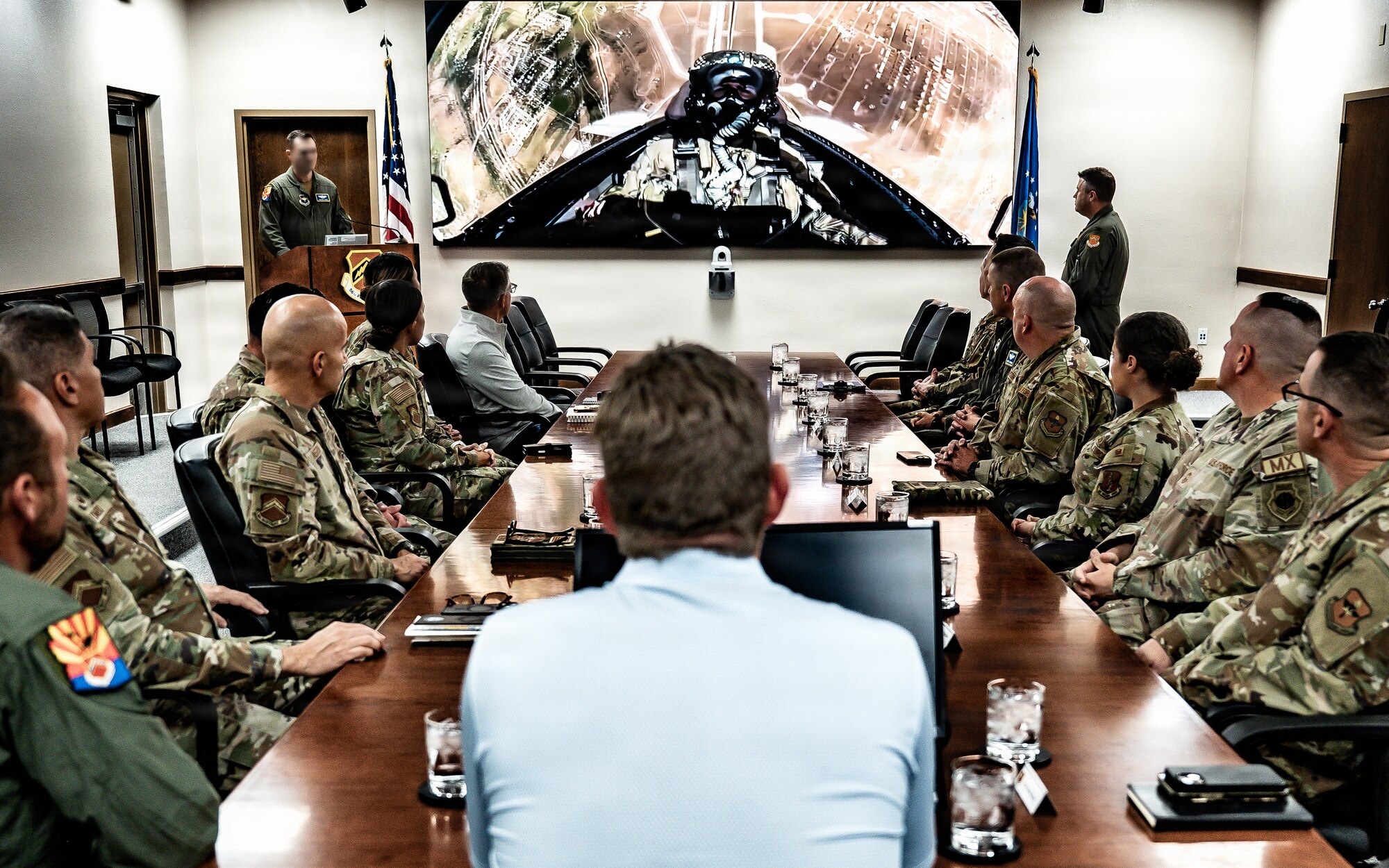 U.S. Air Force Col. John Ryan, 56th Fighter Wing deputy commander, and base leadership give a command mission brief to Mr. Eric Trump during his visit to the installation, Jan. 28, 2026, Luke Air Force Base, Arizona. The briefing highlighted Luke AFB’s mission, capabilities and role in training the world’s greatest fighter pilots and combat ready Airmen. (U.S. Air Force photo by Airman 1st Class Belinda Guachun-Chichay)