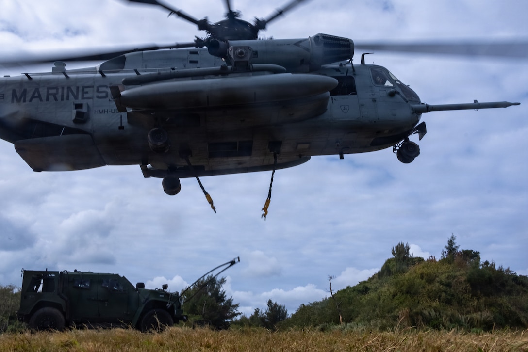 A CH-53 helicopter with Marine Heavy Helicopter Squadron 466, Marine Aircraft Group 16, 1st Marine Air Wing, releases lift cables after an external lift of a Joint Light Tactical Vehicle during a helicopter support team training event at Landing Zone Swan, Okinawa, Japan, Jan. 27, 2026.