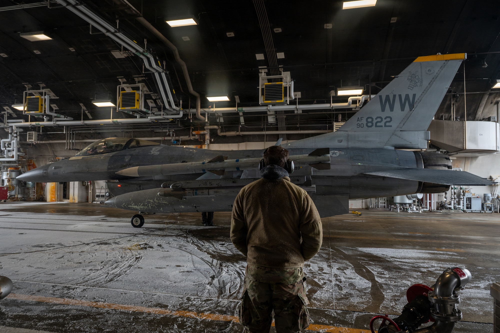 U.S. Air Force Airman 1st Class Cameron Hall, 35th Logistics Readiness Squadron fuels distribution operator, waits for a 14th Fighter Squadron pilot’s signal to refuel an F-16 Fighting Falcon at Misawa Air Base, Japan, Jan. 15, 2026.