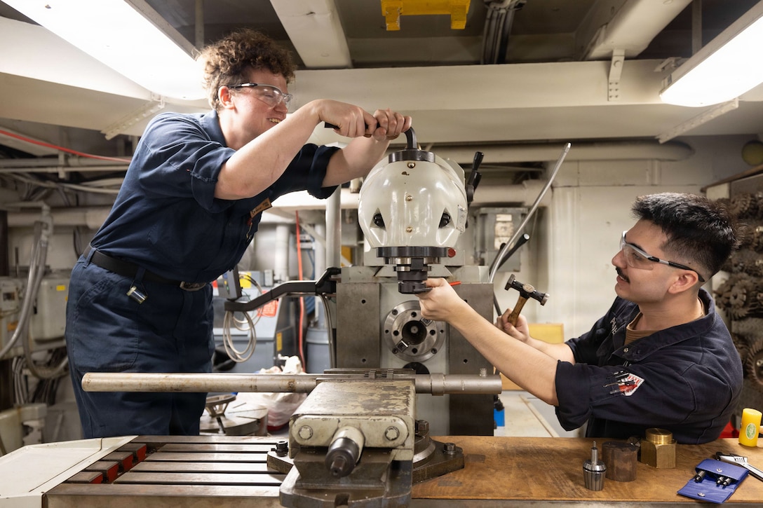 U.S. CENTRAL COMMAND AREA OF RESPONSIBILITY (Jan. 26, 2026) U.S. Navy Machinery Repairman 1st Class Jenifer Iffrig and U.S. Navy Machinery Repairman Fireman Daniel Alexander replace a collet on a milling machine aboard the Nimitz-class aircraft carrier USS Abraham Lincoln (CVN 72) in the U.S. Central Command (CENTCOM) area of responsibility, Jan. 26. Abraham Lincoln is deployed to the U.S. 5th Fleet area of operations to support maritime security and stability in the CENTCOM area of responsibility. (U.S. Navy photo by Mass Communication Specialist Seaman Hannah Tross)