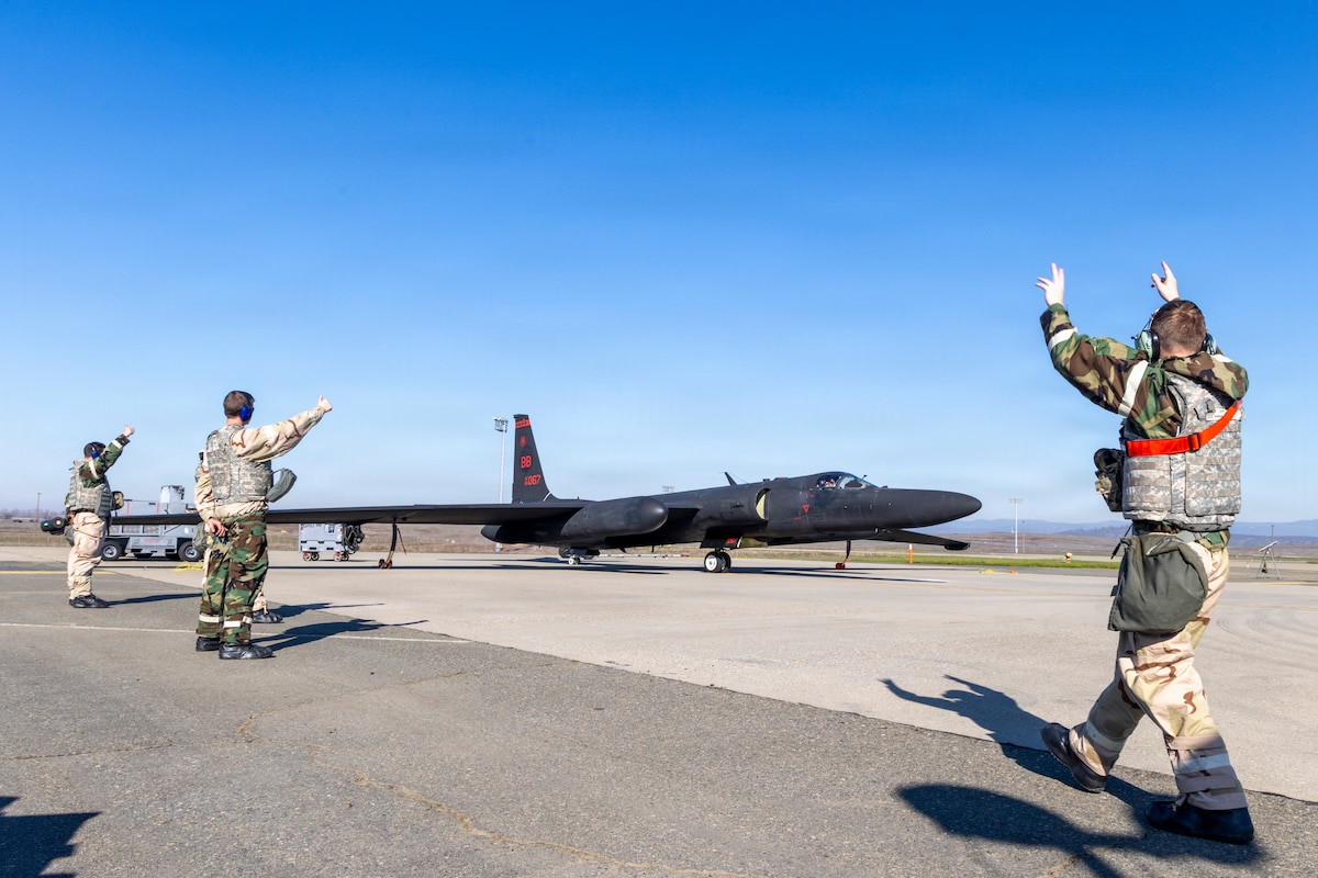 Airmen assigned to the 9th Aircraft Maintenance Squadron marshal a U-2 Dragon Lady during exercise Dragon Shield at Beale Air Force Base, Calif., Jan. 4, 2026. The exercise tested the squadron’s ability to generate aircraft in a simulated contested environment while operating under austere conditions and varying mission-oriented protective posture levels. (U.S. Air Force photo by Senior Airman Frederick Brown)