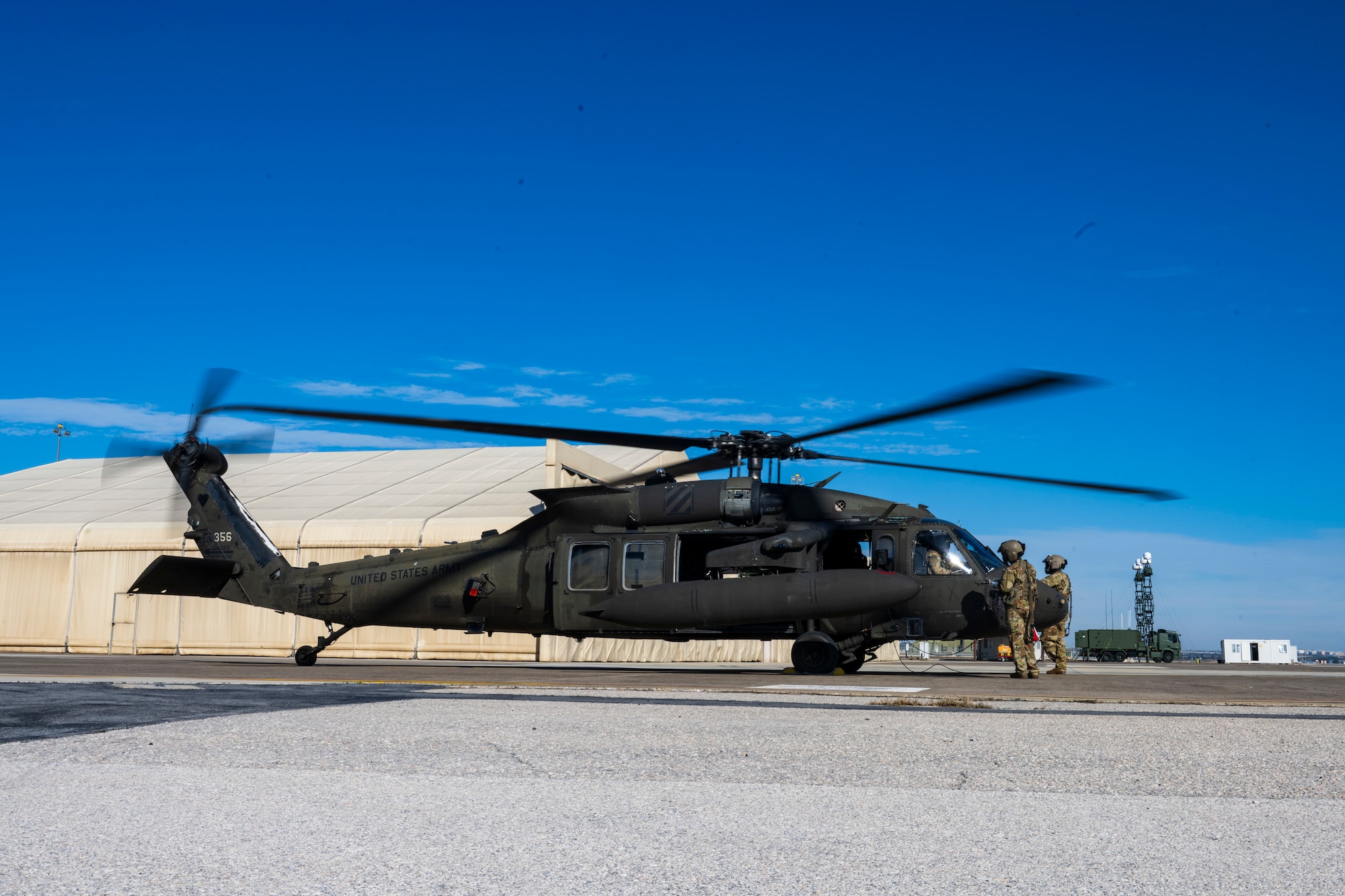 A UH-60 Black Hawk helicopter idles on the flight line